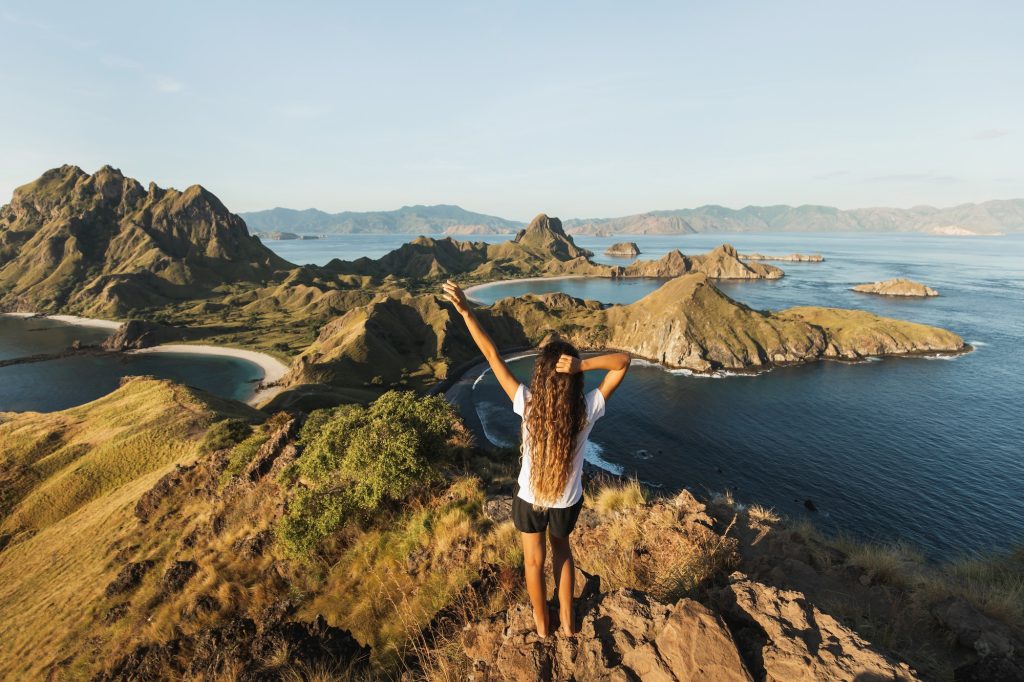 woman with amazing view of padar island in komodo national park indonesia enjoying tropical